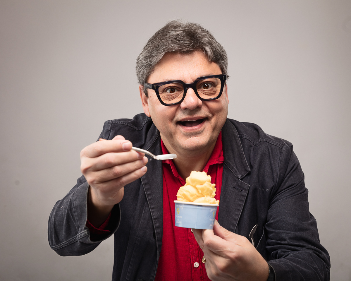 Man enjoying ice cream with a spoon.