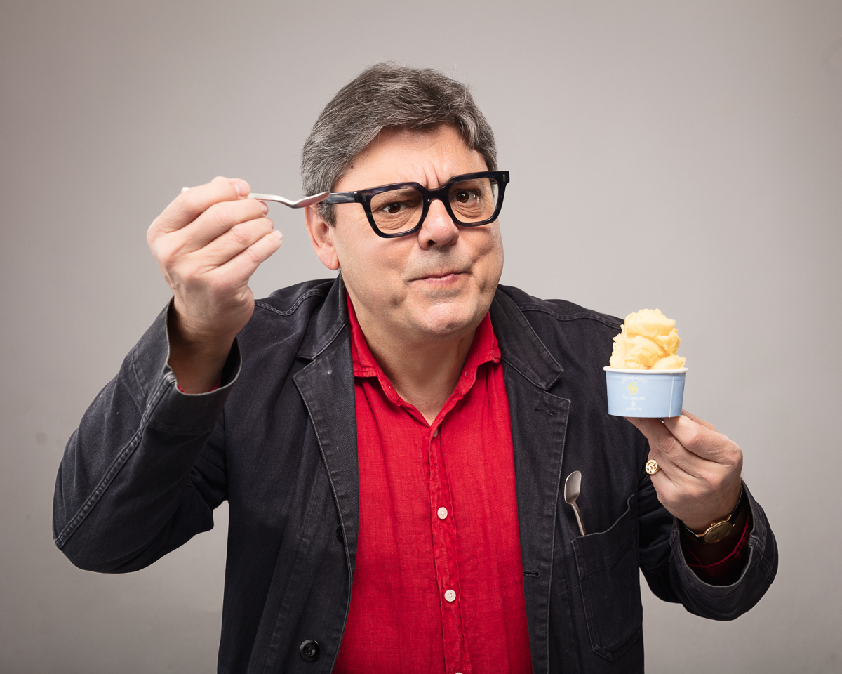 Man enjoying ice cream with spoon.