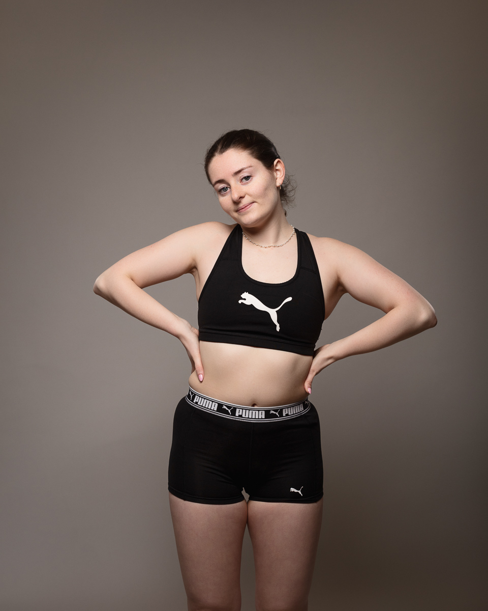 Person in black Puma sportswear posing confidently.