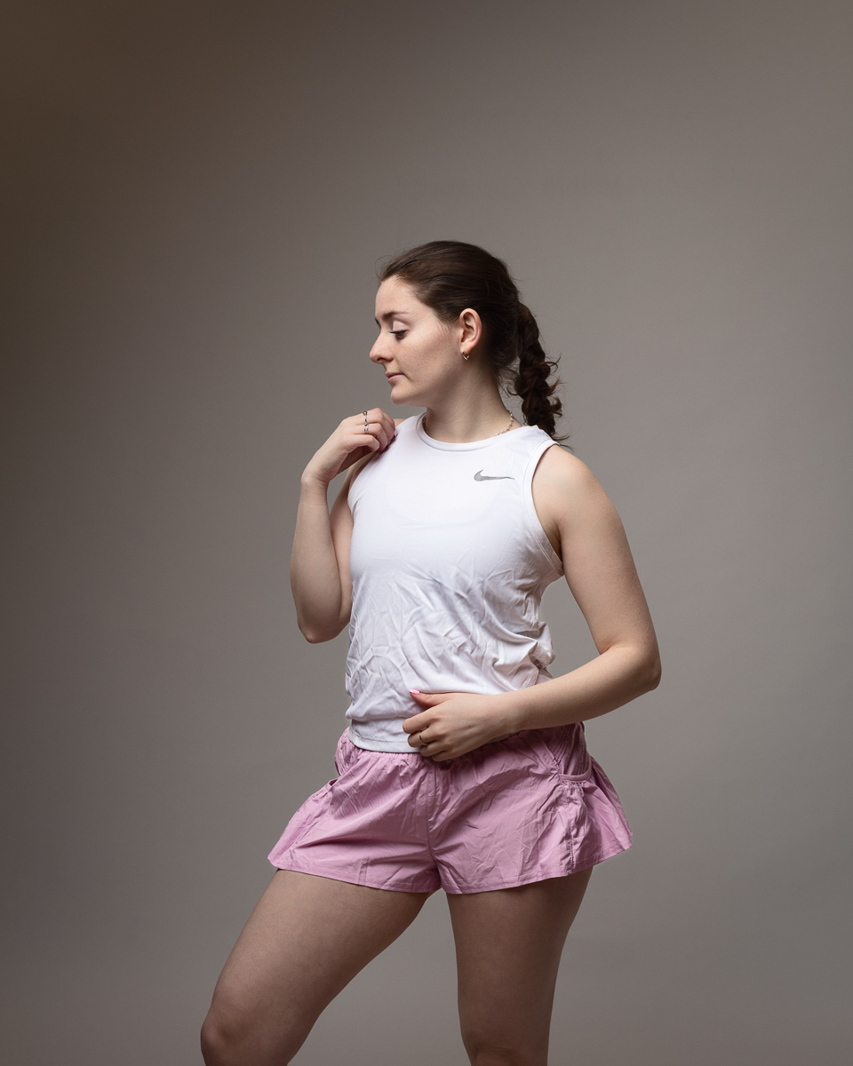 Woman posing in athletic wear, studio photo.