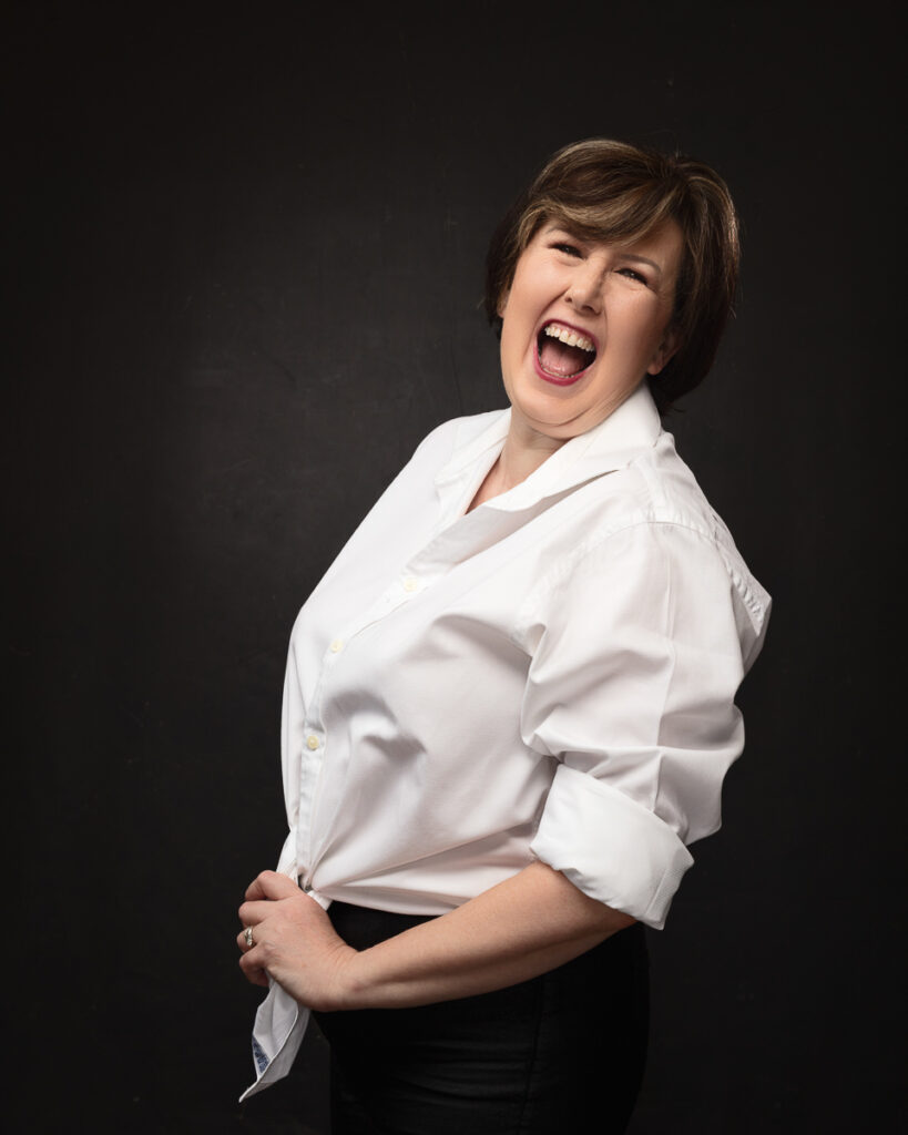 Person in white shirt laughing joyfully.
