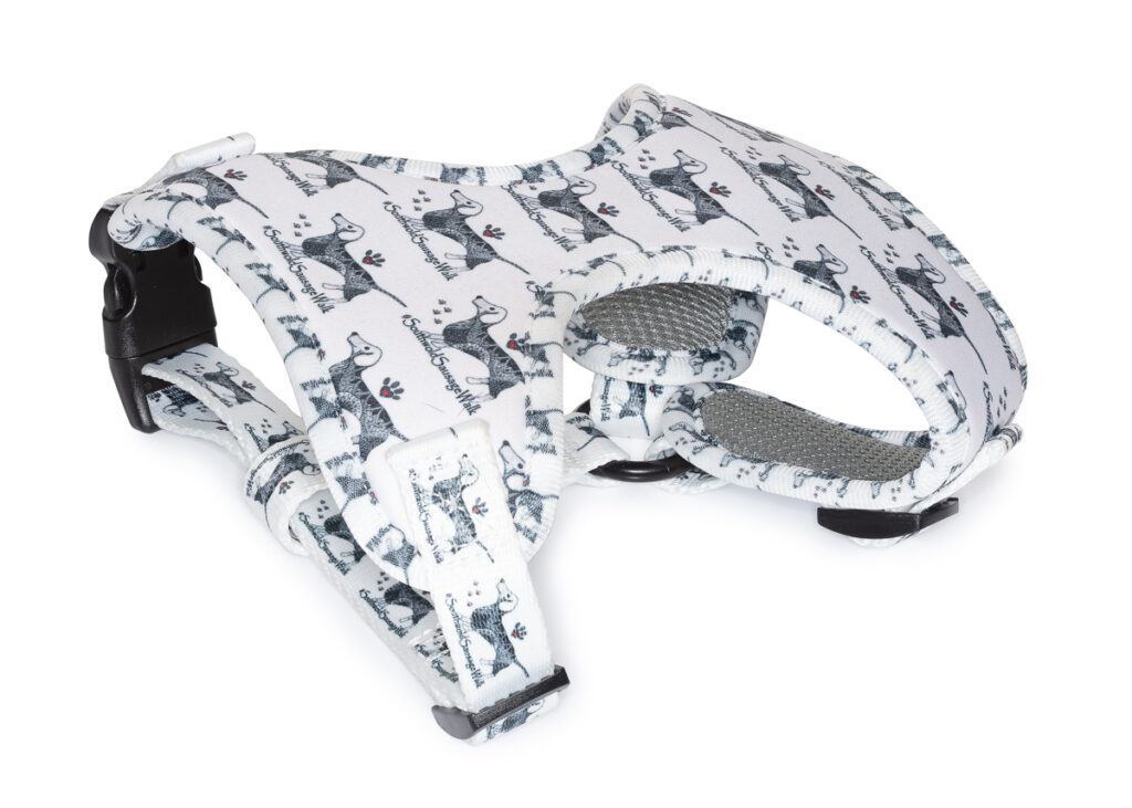 Dog harness with playful animal print design.