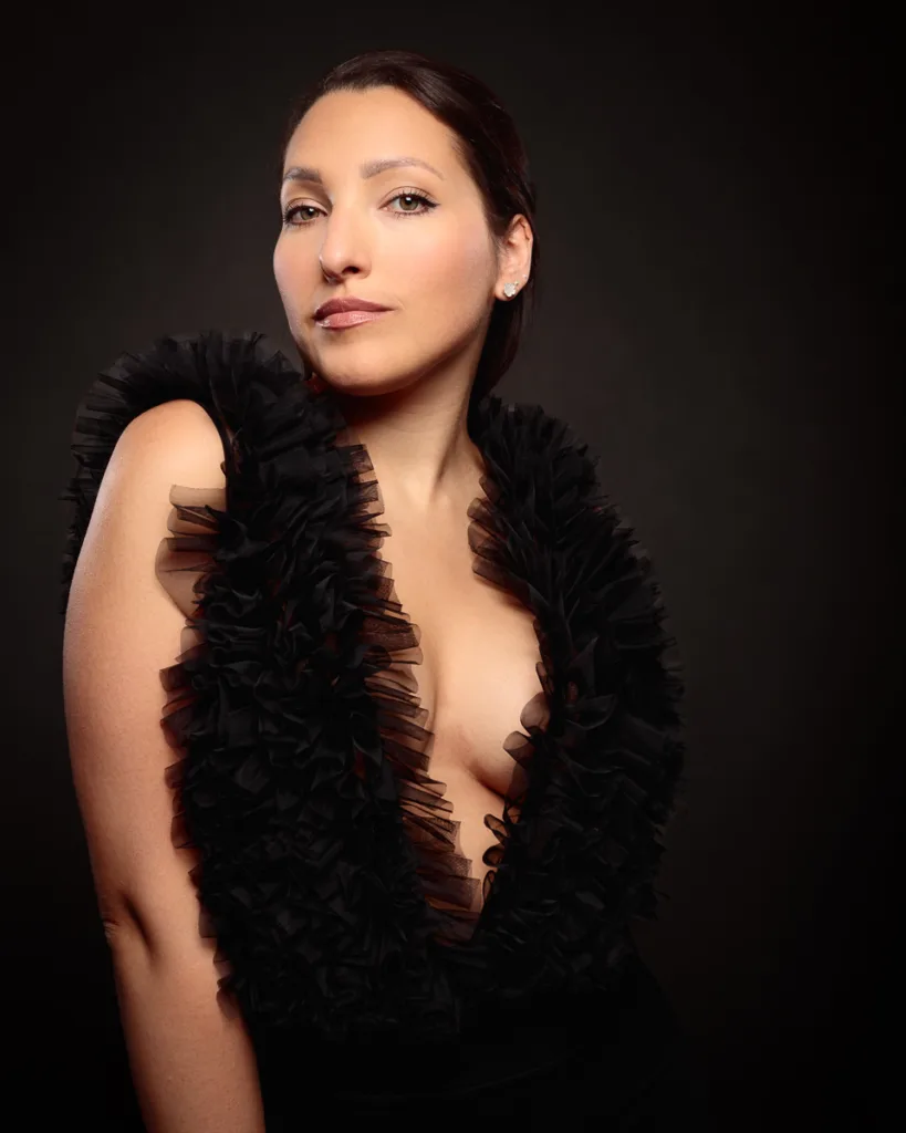 Woman in elegant black outfit, studio portrait