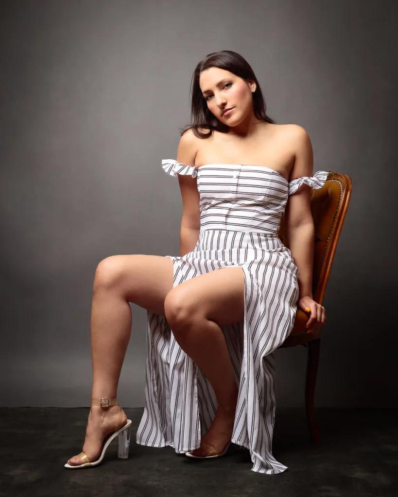 Woman in striped dress sitting on chair