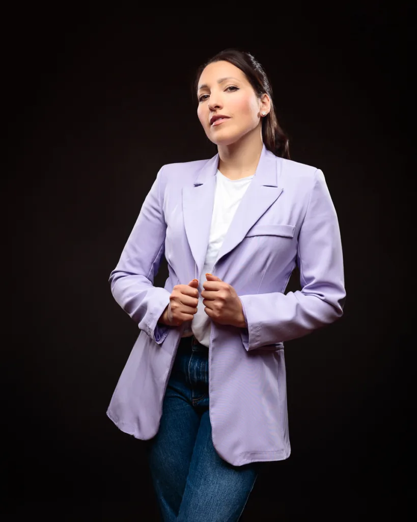 Person in purple blazer posing confidently