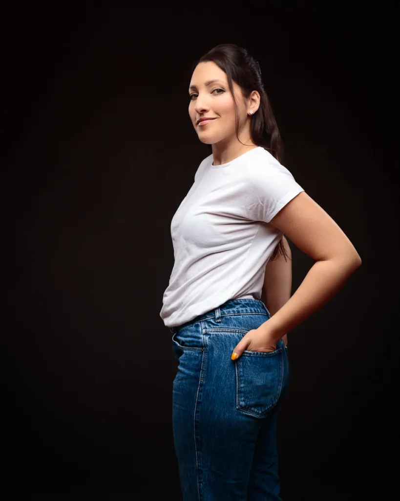 Person posing in white shirt and jeans.