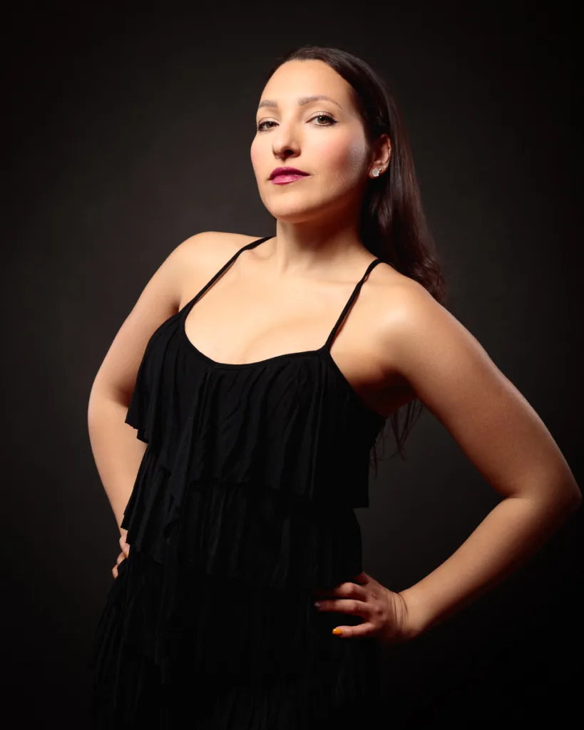 Woman in black dress posing confidently