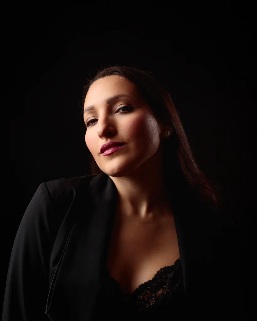 Woman posing confidently in dim light