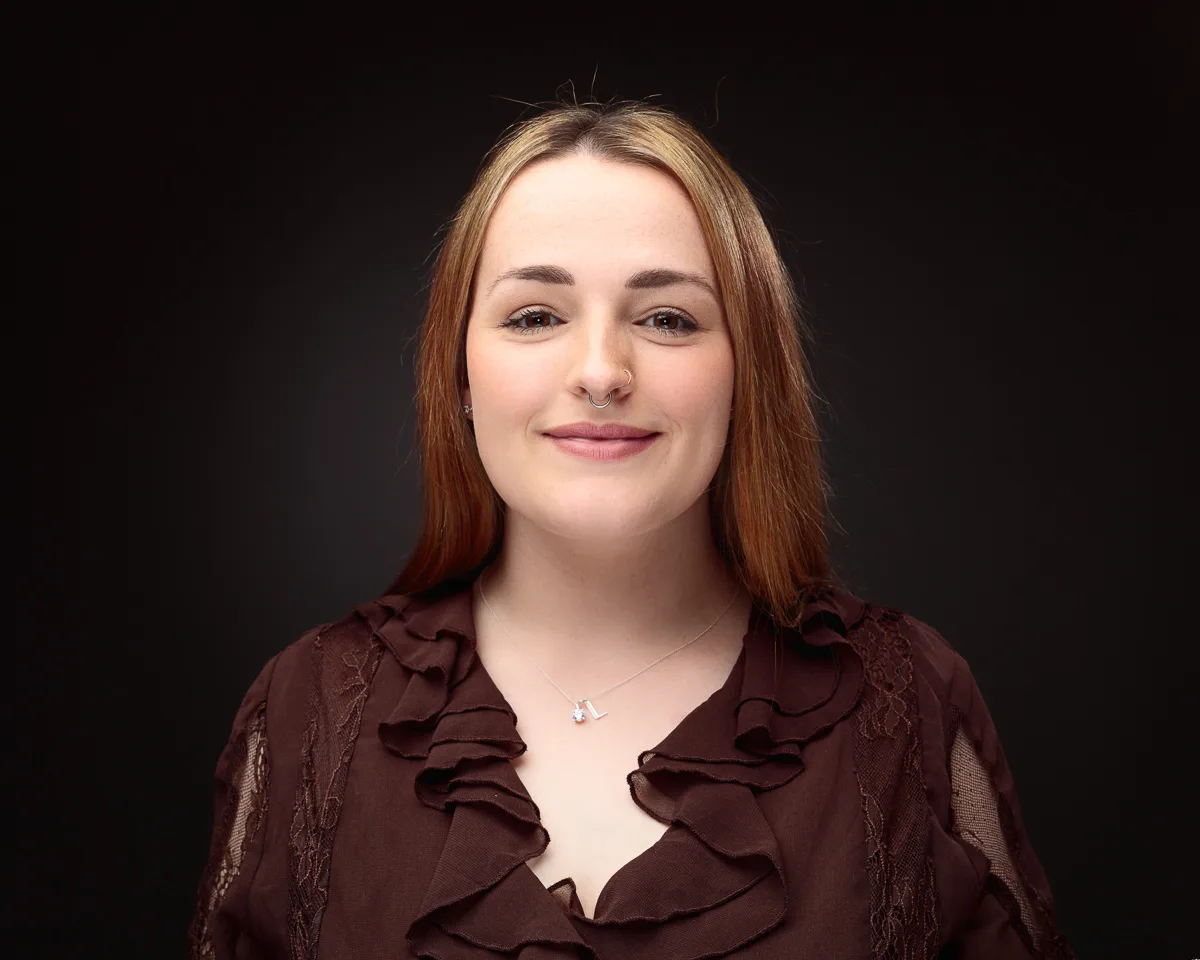 Person smiling in dark background portrait