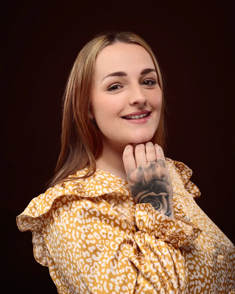 Smiling woman with tattooed hand and nose ring