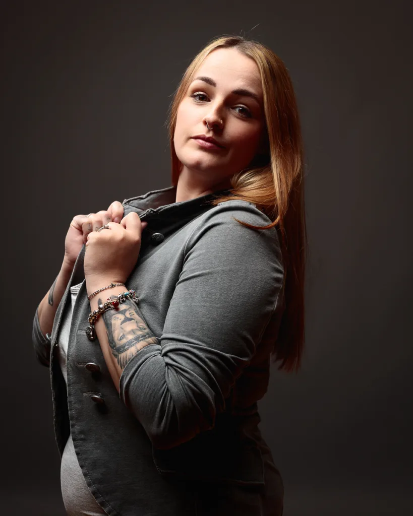 Woman posing confidently in grey blazer