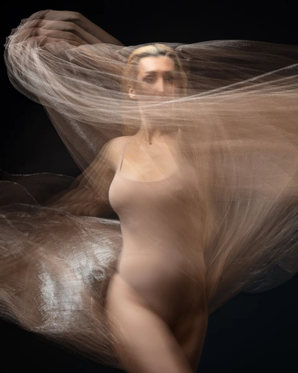Illusionary dance with flowing sheer fabric
