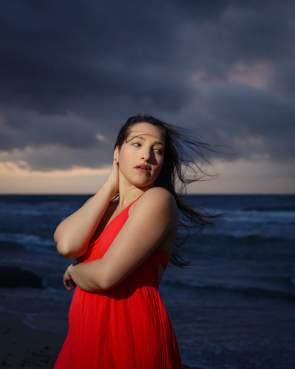 Woman in red dress by the sea