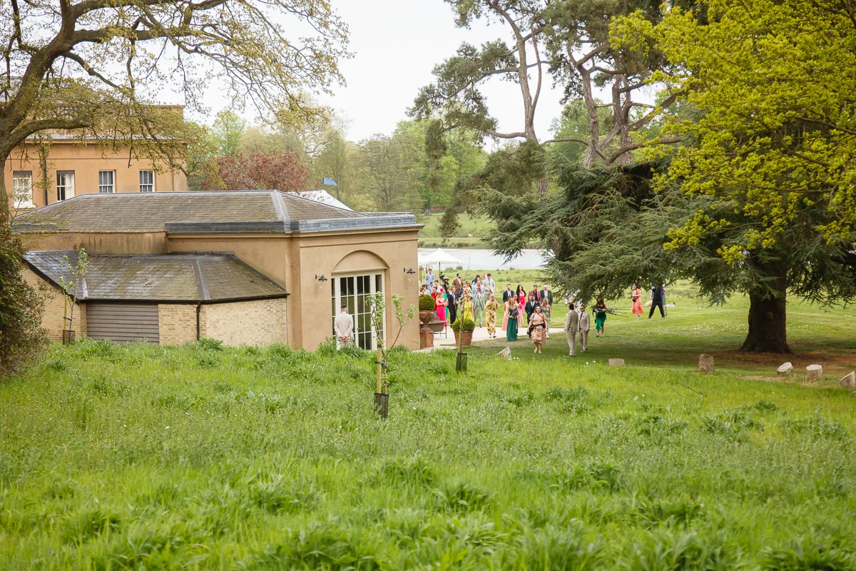 People gathered outside a historic building in nature.