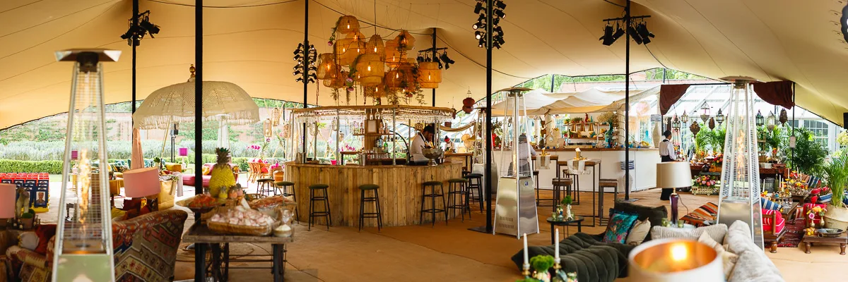 Stylish outdoor event with bar and seating area.