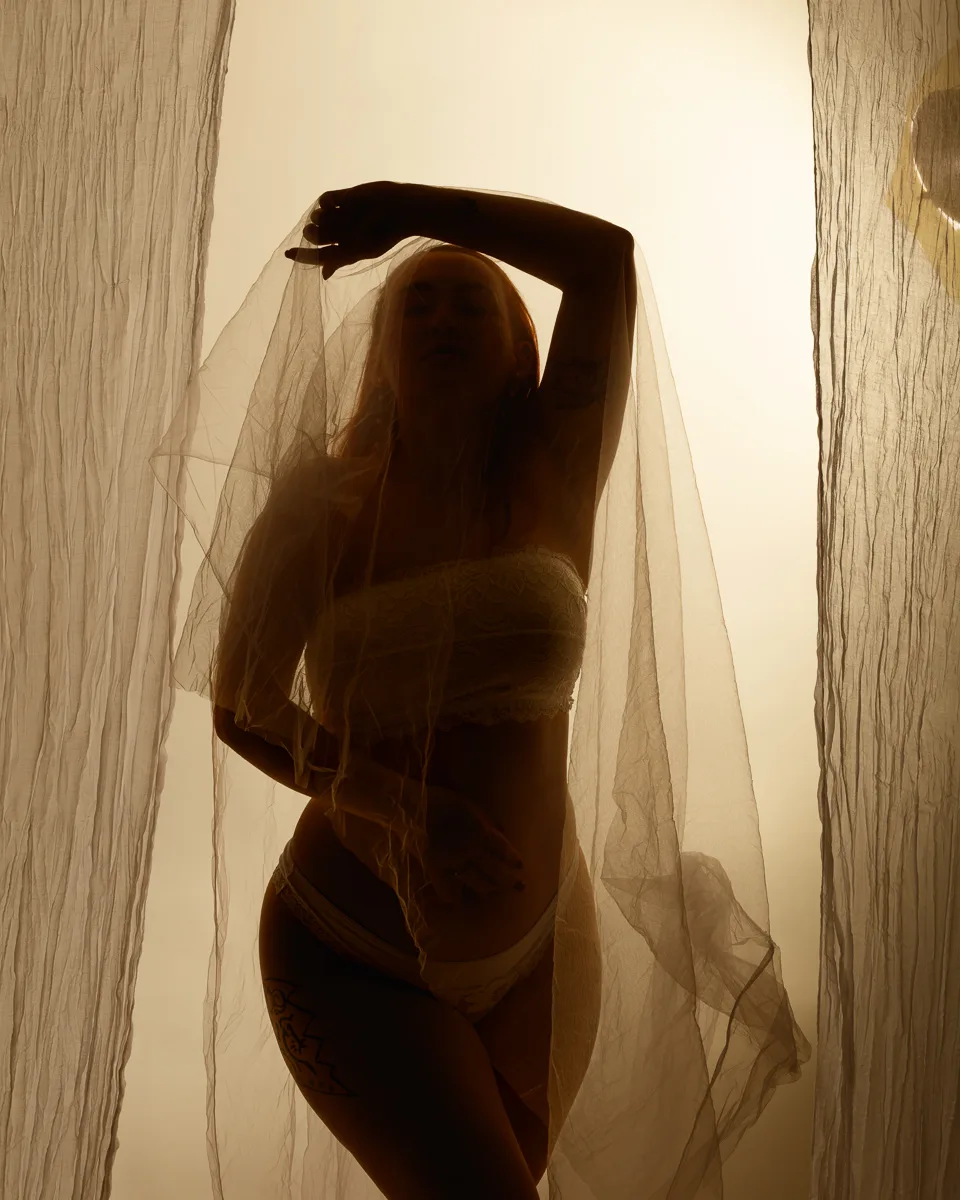 Silhouette of person behind sheer fabric