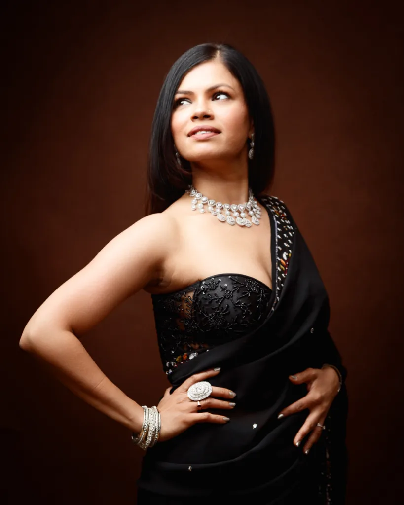 Woman in elegant black dress with jewellery.