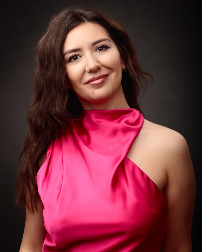 Woman in elegant pink dress smiling