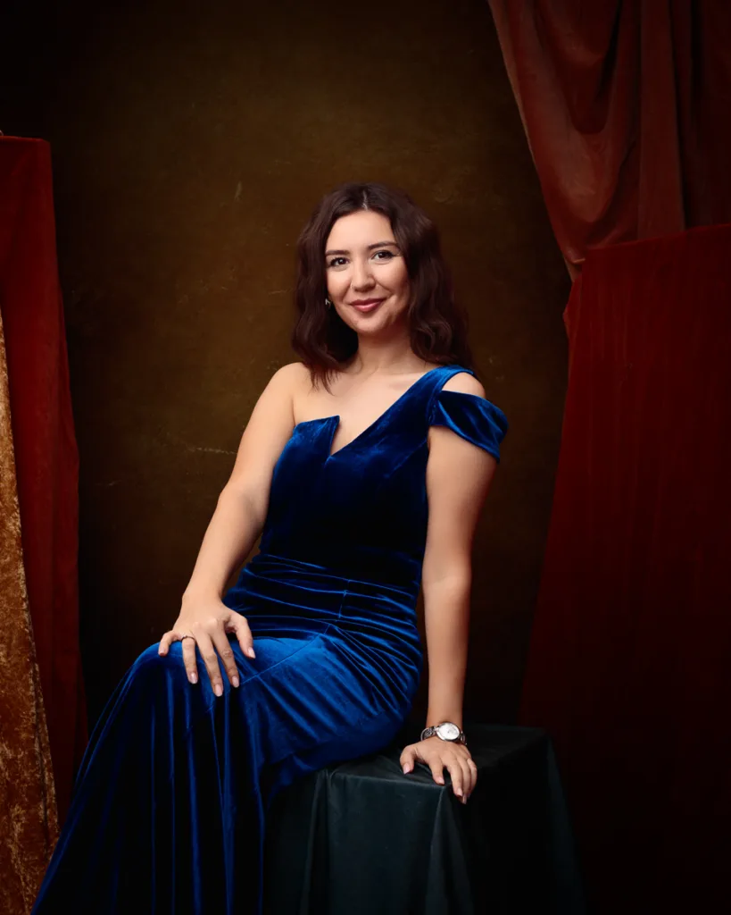Woman in blue velvet dress smiling
