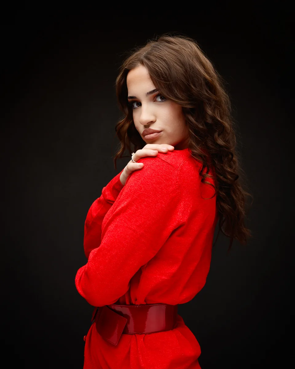 Woman in red dress, dark background
