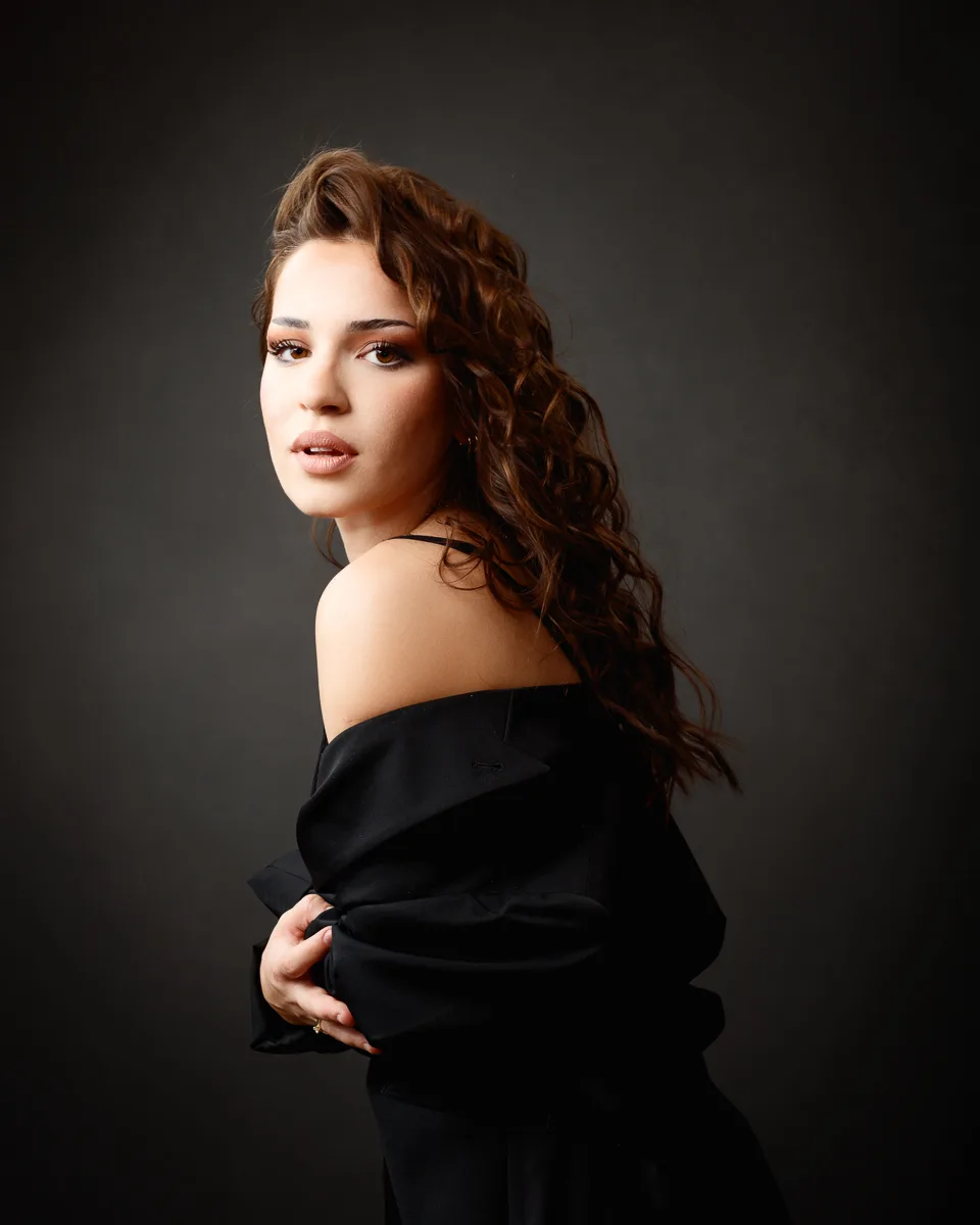 Woman in black attire posing confidently