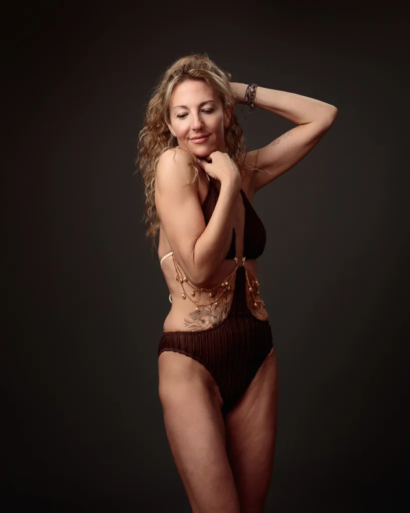 Woman in stylish brown swimsuit posing confidently.