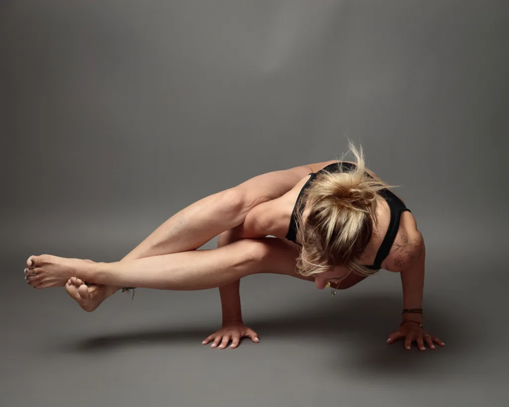 Person performing advanced yoga balance pose.