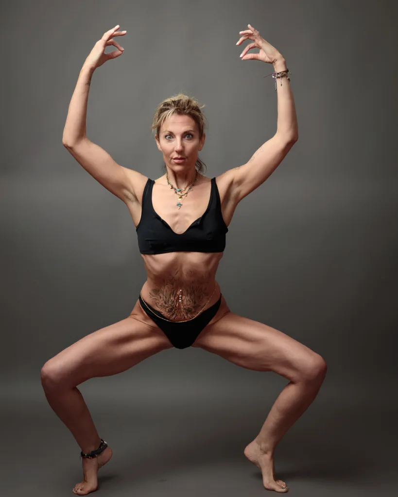 Woman in black performing a dance pose