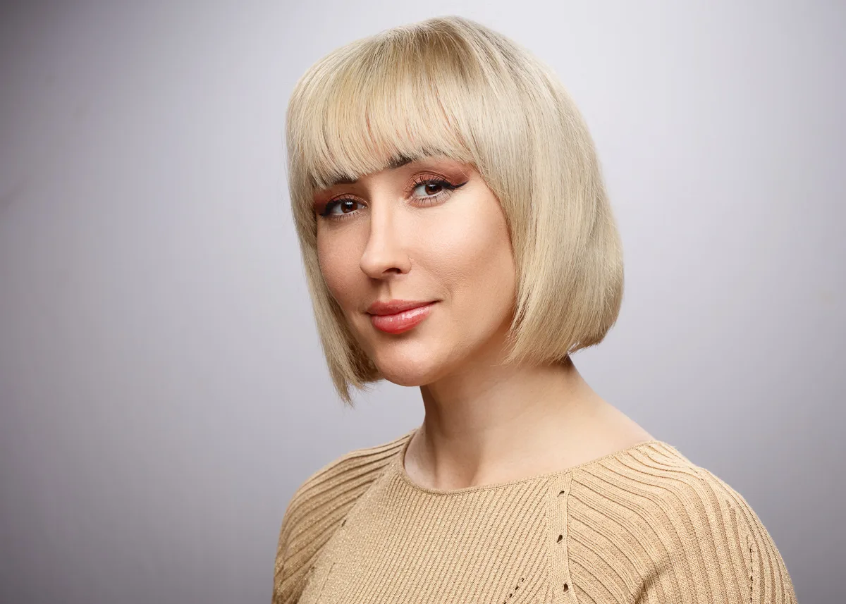 Smiling woman with short blonde bob haircut