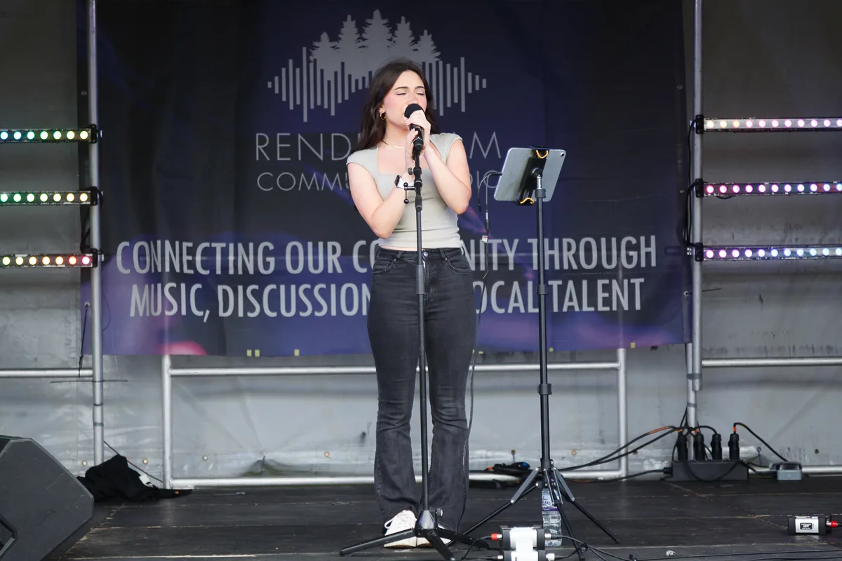 Singer performing on community stage event.