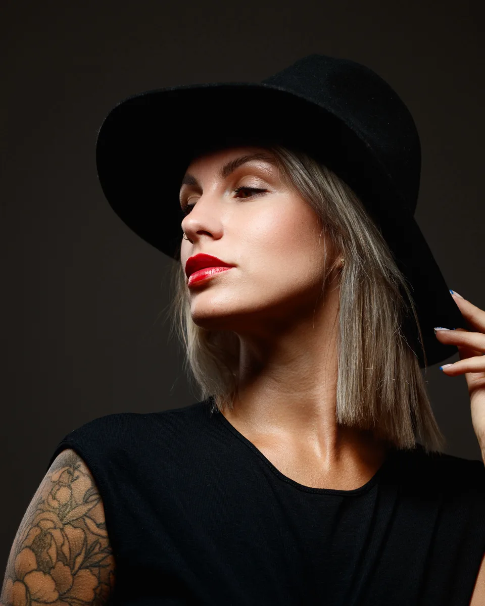 Woman with hat and tattoo, stylish portrait