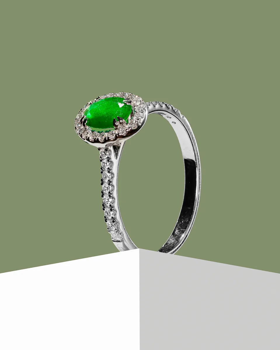 Silver ring with green gemstone and small diamonds