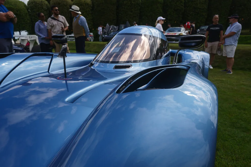 Blue car with reflections at outdoor event
