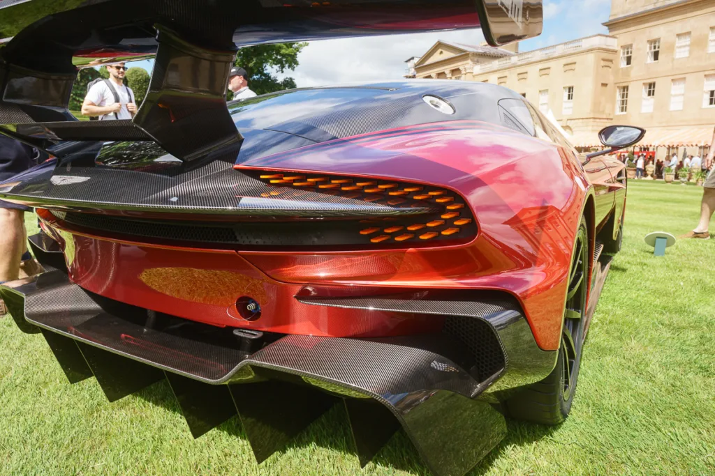 Red sports car showcased at a car event