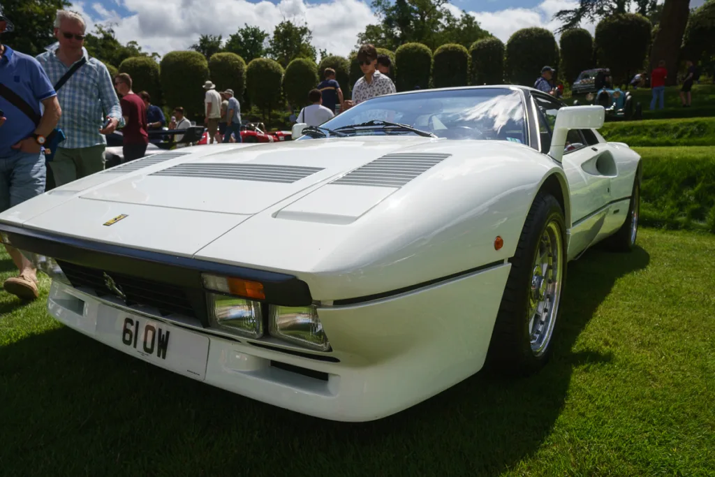 White classic sports car on display outdoors