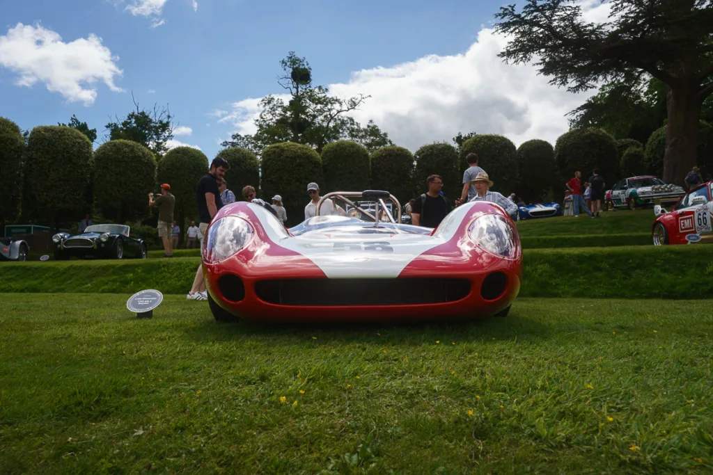 Vintage red race car on display at event.