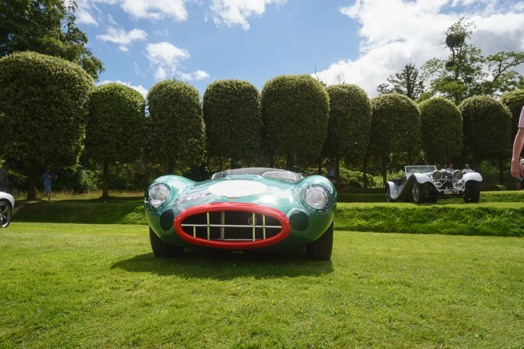 Vintage green race car on grassy field
