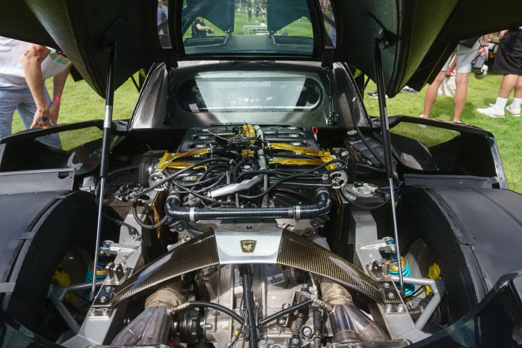 Open car engine with visible components on display.