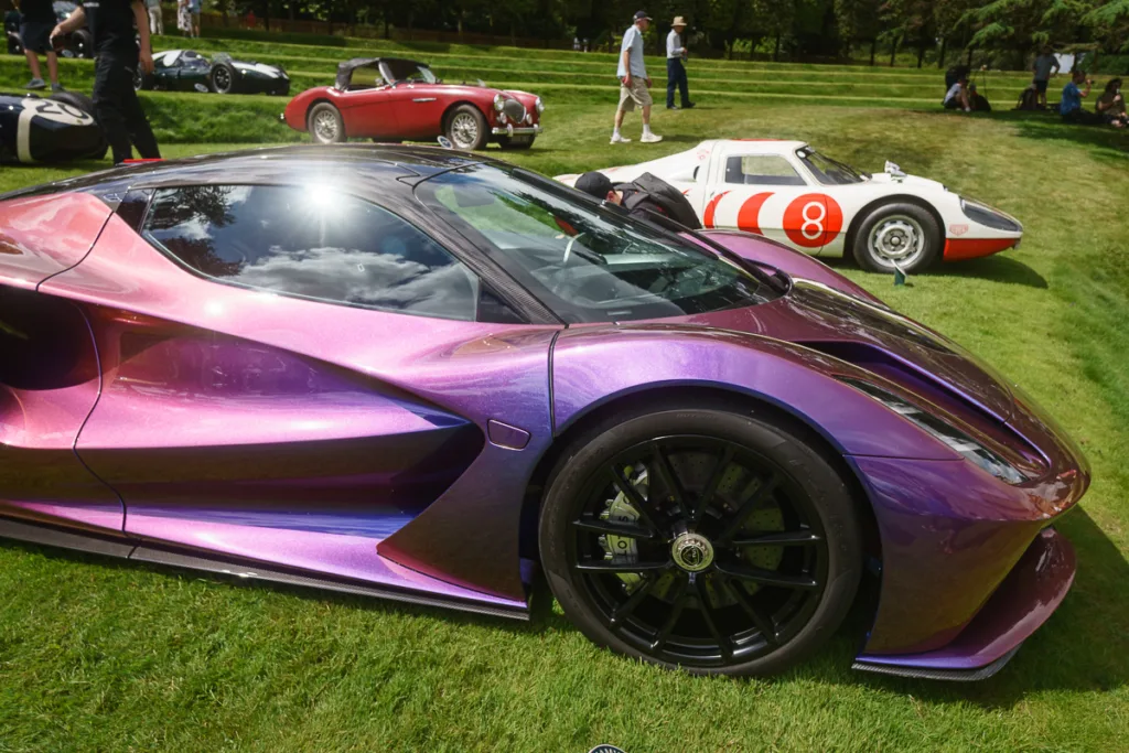 Sleek purple supercar at outdoor auto show