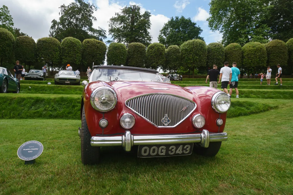 Classic red Austin-Healey car on display outdoors