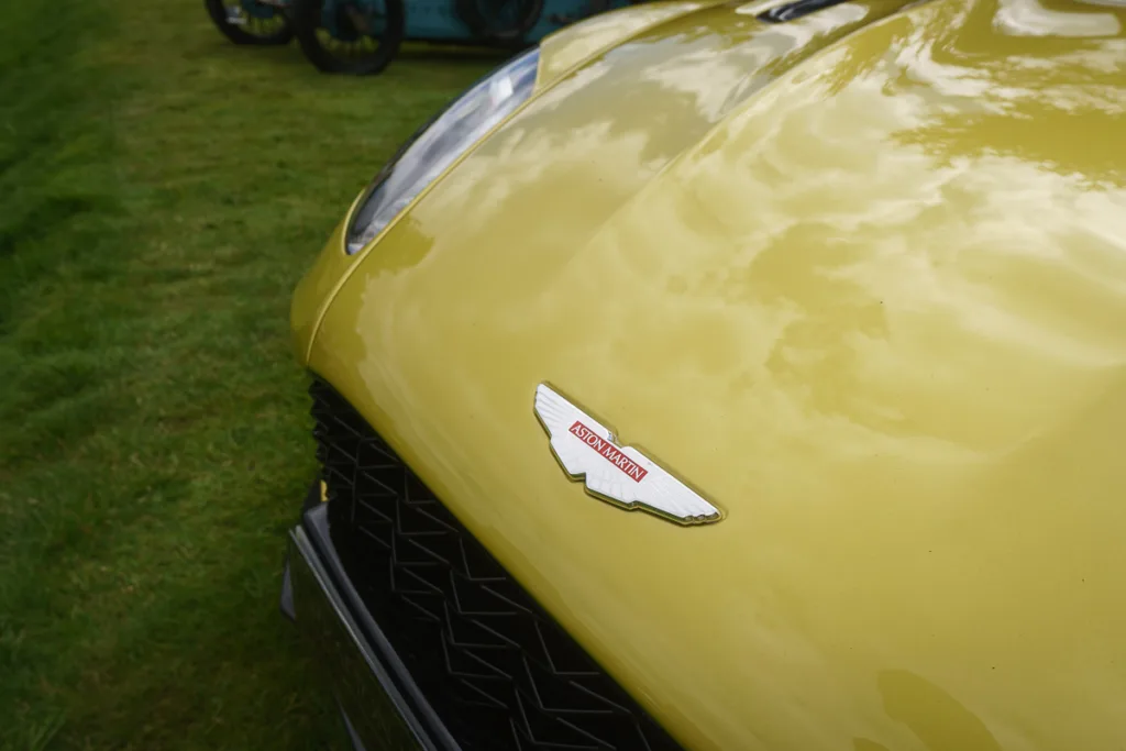 Yellow Aston Martin car bonnet and badge close-up