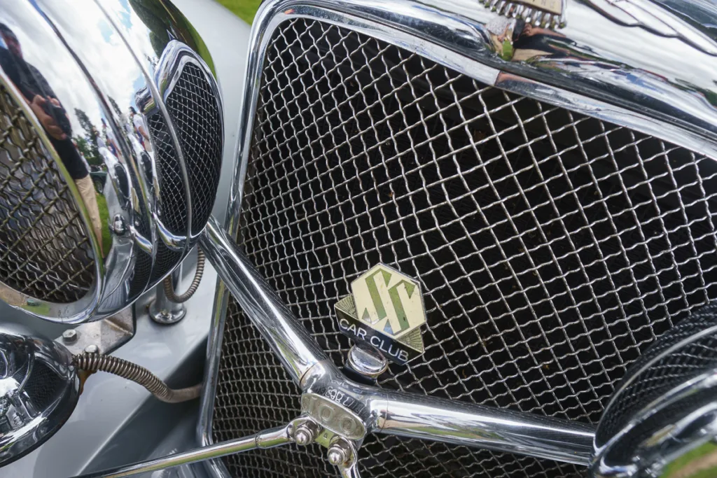 Classic car grille with car club emblem.