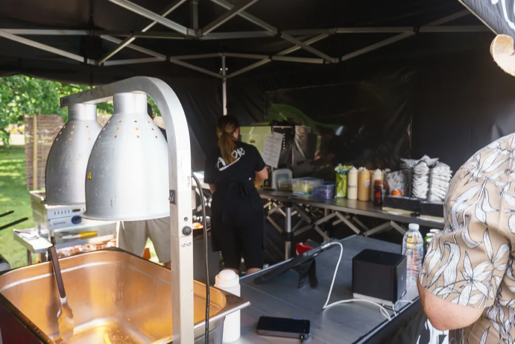 Food stand with cooking equipment and condiments.