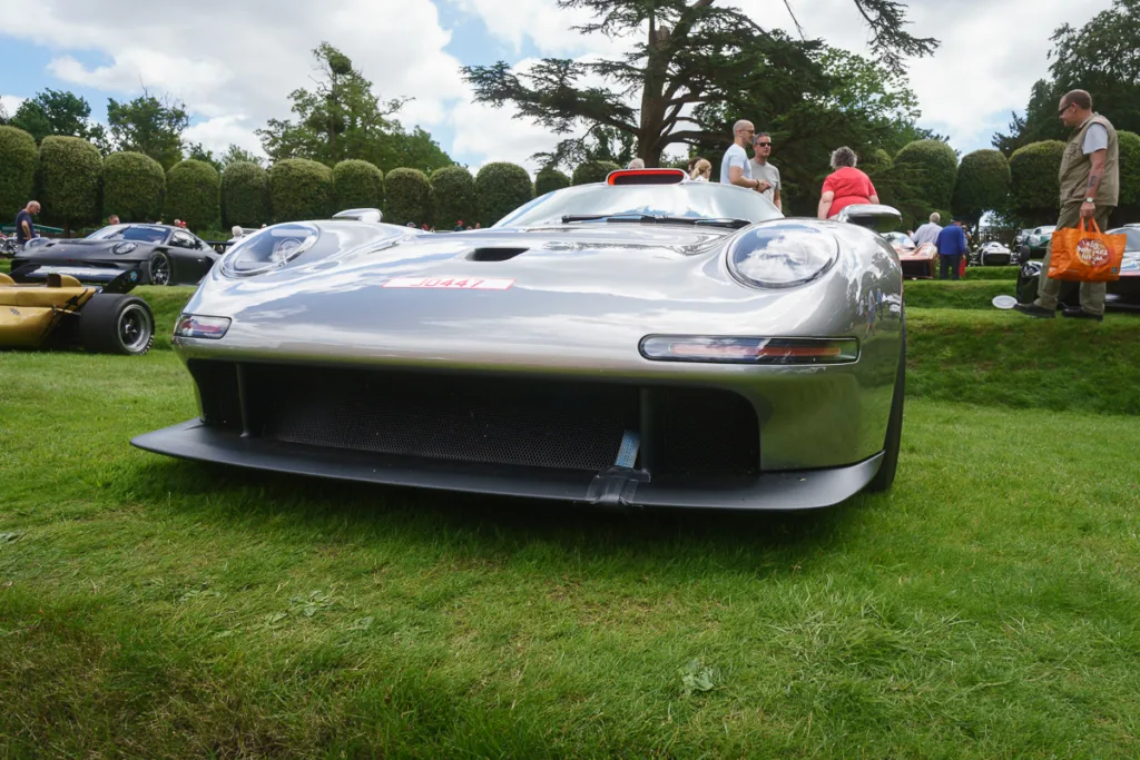 Silver sports car at outdoor event.