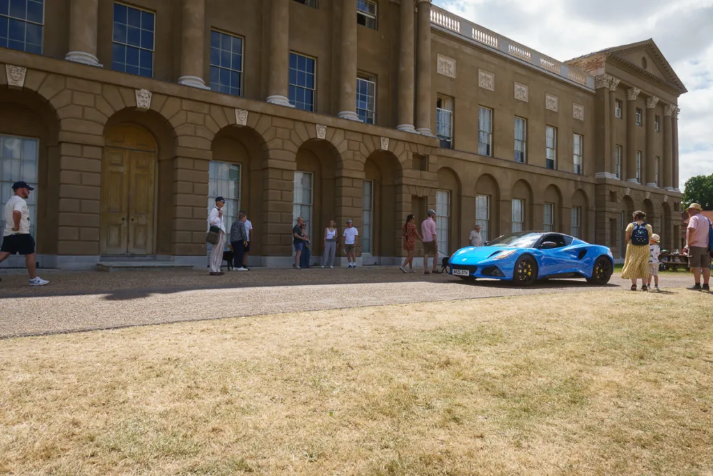 Blue sports car parked outside historic building