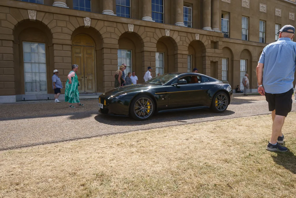 Black sports car outside historic building