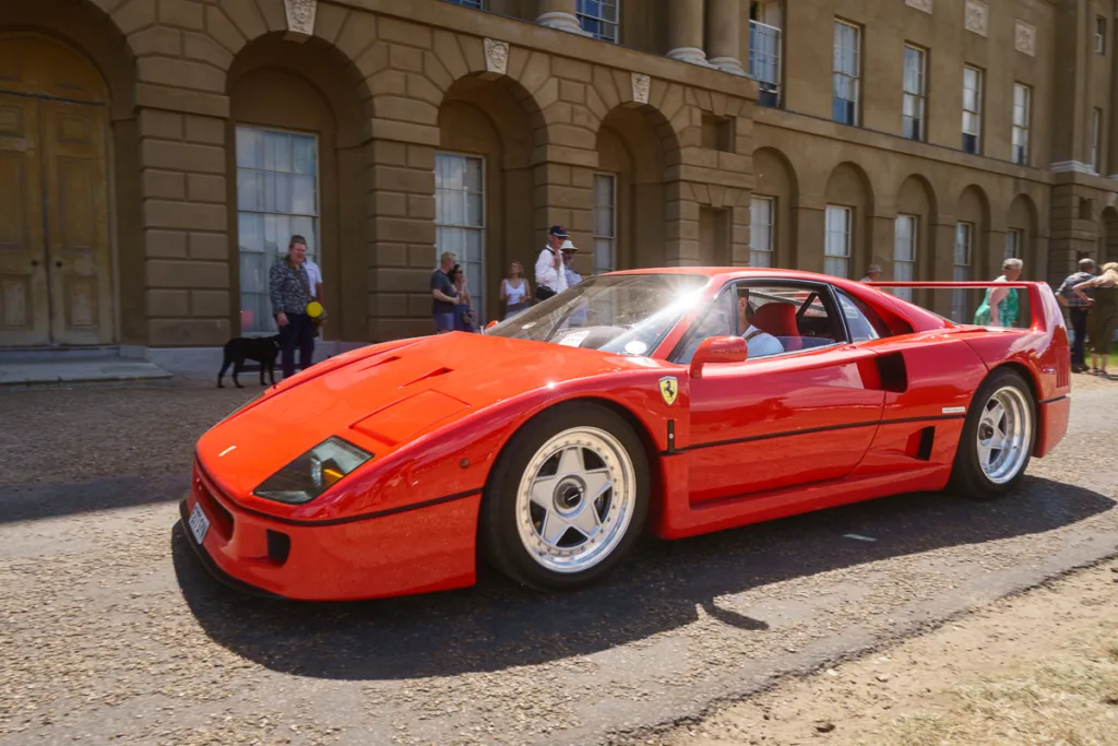 Classic red sports car in front of historic building