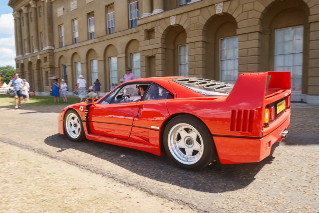 Red Ferrari in front of historic building
