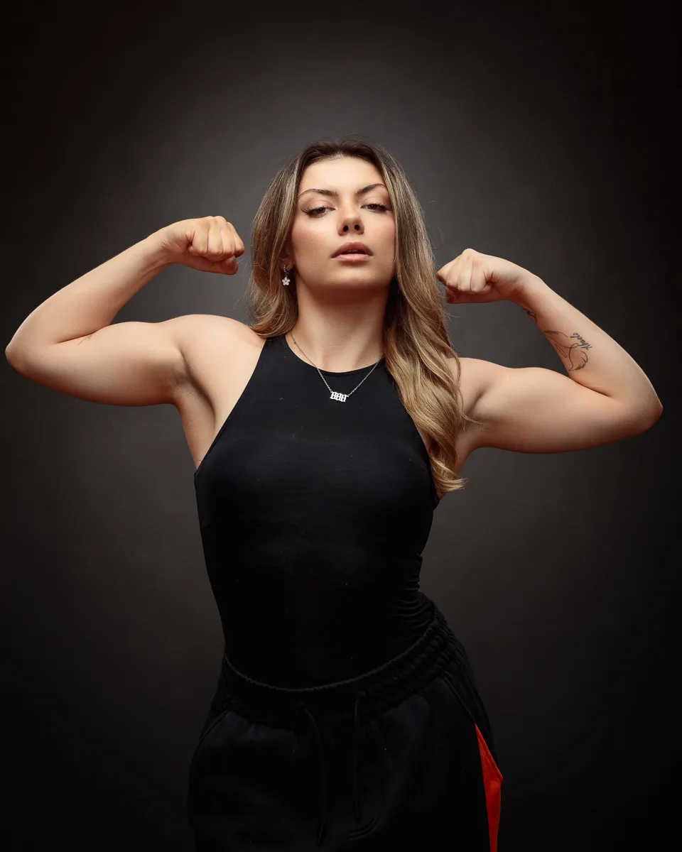 Woman flexing muscles in gym attire.