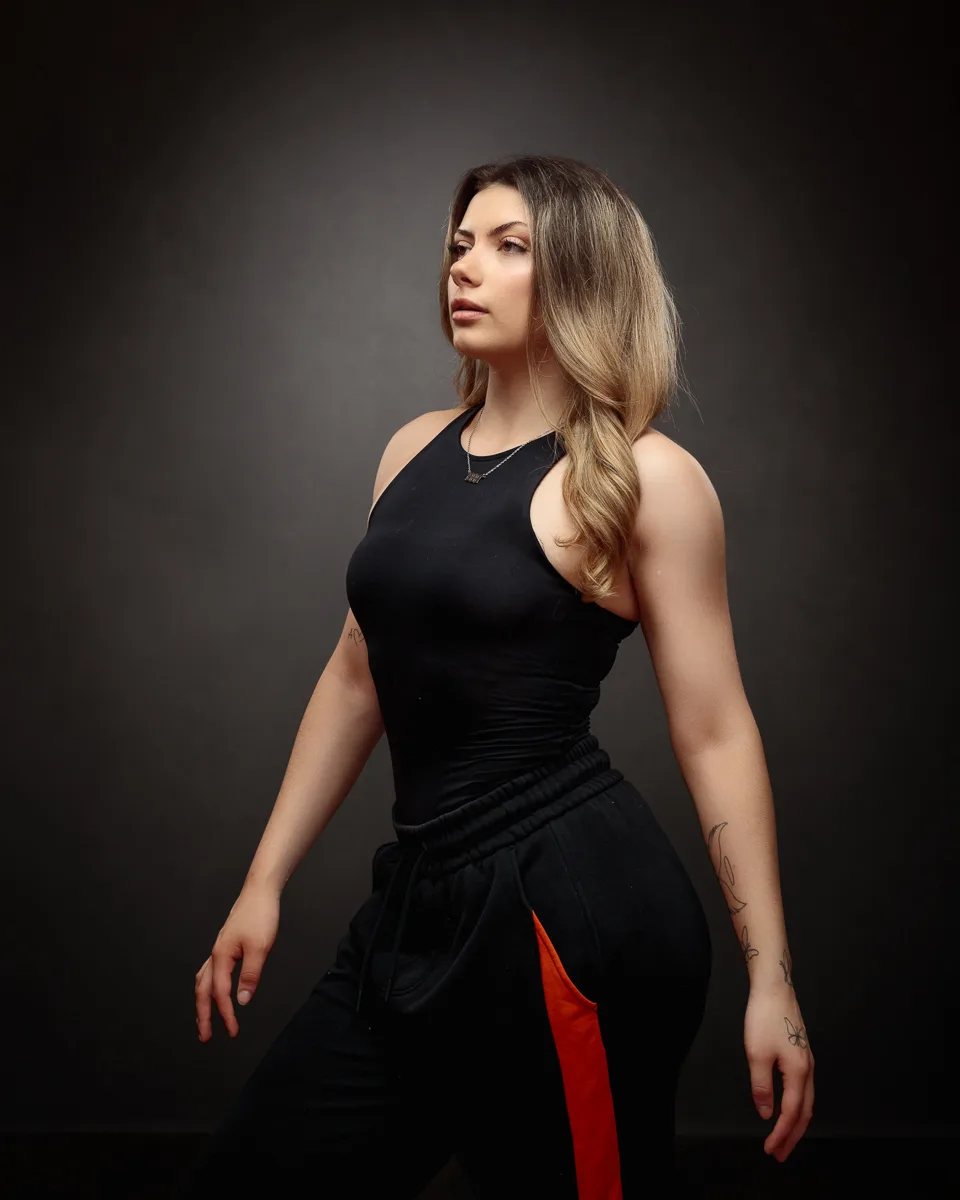 Person in black outfit posing confidently.